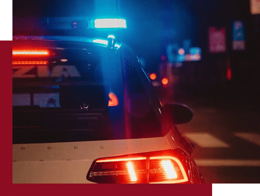 A police car with its lights on at night.